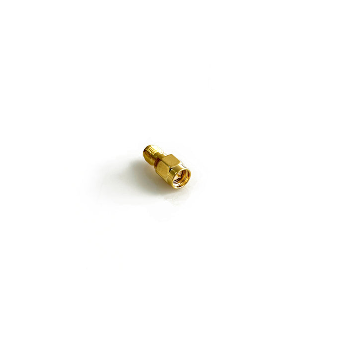 An SMA male to female barrel adaptor against a white background
